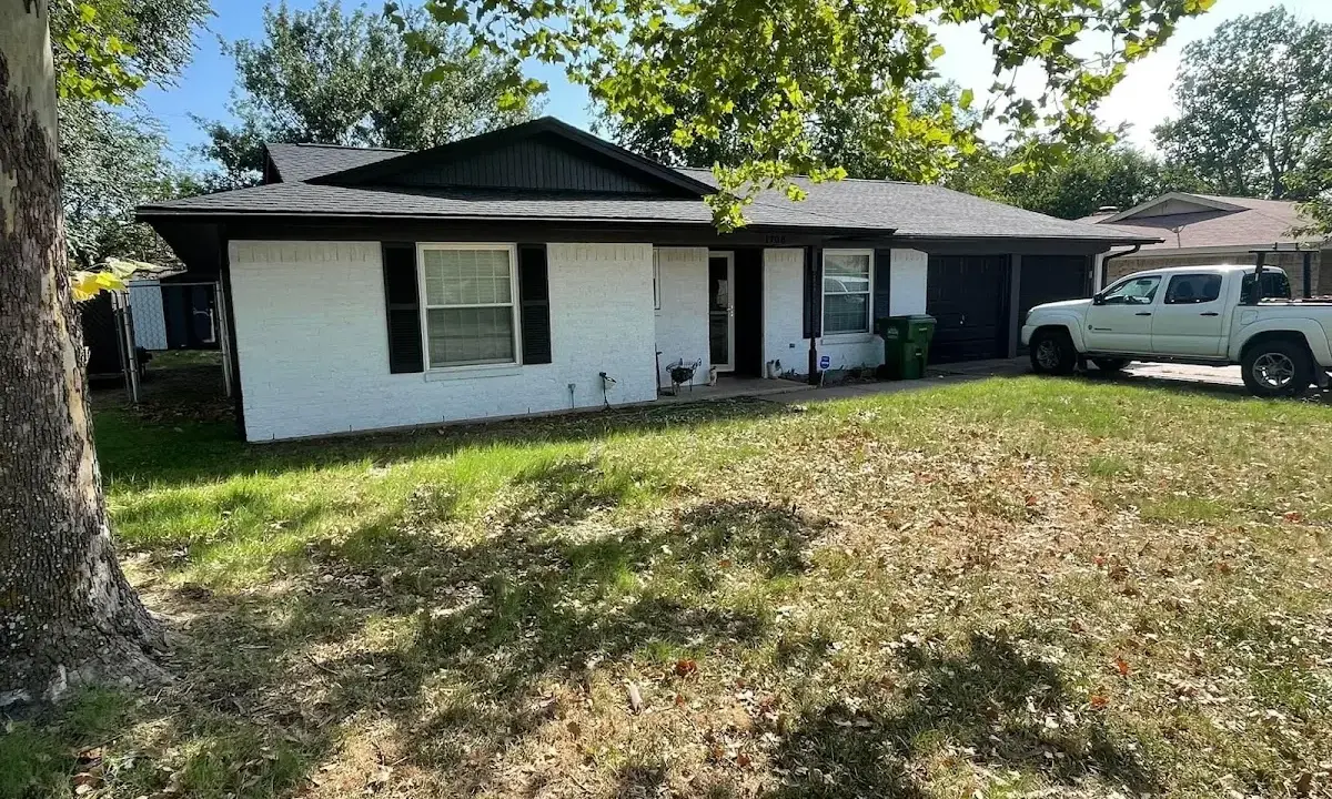 Professional roofing crew working on a residential roof in Teaneck